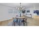 Bright dining room with round wooden table and modern chandelier at 5718 Magnolia N St, St Petersburg, FL 33703