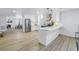 Modern kitchen featuring white cabinets, stainless steel appliances, and a breakfast bar at 5718 Magnolia N St, St Petersburg, FL 33703