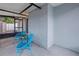 Cozy patio with two blue chairs and a small table, adjacent to a brick wall at 5718 Magnolia N St, St Petersburg, FL 33703