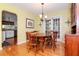 Bright dining room features hardwood floors, a wood table with chairs, and access to the kitchen at 6005 N 9Th St, Tampa, FL 33604