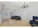 Living room with a sectional sofa, tile floor, and chandelier at 6406 S Richard Ave, Tampa, FL 33616