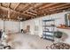 Unfinished basement with garage access and storage shelving at 6702 Sandra Dr, Port Richey, FL 34668