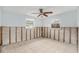 Under-renovation bedroom with exposed walls, tiled floor, and ceiling fan at 6702 Sandra Dr, Port Richey, FL 34668