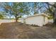 Large backyard with a shed and mature trees providing shade at 674 Frederica Ln, Dunedin, FL 34698