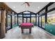 Sunroom addition with pool table and access to backyard at 7226 Alafia Ridge Loop, Riverview, FL 33569