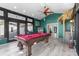 Game room features a pool table, wet bar, and plenty of space for entertainment at 7226 Alafia Ridge Loop, Riverview, FL 33569