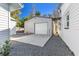 Detached garage with roll-up door and gravel area at 7226 Alafia Ridge Loop, Riverview, FL 33569