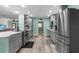 Modern kitchen with stainless steel appliances and gray cabinets at 7226 Alafia Ridge Loop, Riverview, FL 33569
