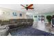 Living room with gray sectional and access to sunroom at 7226 Alafia Ridge Loop, Riverview, FL 33569