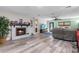 Bright living room featuring a fireplace and wood-look flooring at 7226 Alafia Ridge Loop, Riverview, FL 33569