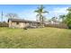 Large backyard with grassy area and home view at 8517 Horizon Ln, Hudson, FL 34667