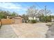 House with driveway, wooden fence, and mature trees in the yard at 8517 Horizon Ln, Hudson, FL 34667