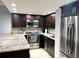 Modern kitchen with granite countertops and stainless steel appliances at 880 Mandalay Ave # N102, Clearwater Beach, FL 33767