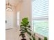 Bright and airy entryway featuring a modern chandelier and plantation shutters at 1069 River Wind Cir, Bradenton, FL 34212