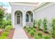 Elegant entryway with arched doorways and meticulously designed landscaping at 1069 River Wind Cir, Bradenton, FL 34212