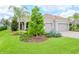 Luxury home showcasing extensive landscaping and a three-car garage at 1069 River Wind Cir, Bradenton, FL 34212