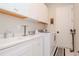 Laundry room with white cabinets and washer/dryer at 1069 River Wind Cir, Bradenton, FL 34212