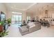 Open floor plan living room with a large TV and access to the backyard pool at 1069 River Wind Cir, Bradenton, FL 34212