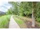 Paved walkway winds through lush landscaping, offering a serene community atmosphere at 1069 River Wind Cir, Bradenton, FL 34212