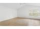 Spacious bedroom with vaulted ceiling, tile flooring and window at 15890 Sanctuary Dr, Tampa, FL 33647