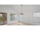 Bright dining room with chandelier and backyard view at 15890 Sanctuary Dr, Tampa, FL 33647
