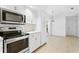 Modern kitchen with stainless steel appliances and white cabinets at 15890 Sanctuary Dr, Tampa, FL 33647