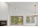 Bright living room with vaulted ceiling, fireplace and sliding doors at 15890 Sanctuary Dr, Tampa, FL 33647
