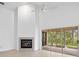 Living room with vaulted ceiling, fireplace and sliding doors at 15890 Sanctuary Dr, Tampa, FL 33647