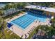 Community lap pool with lounge chairs and surrounding greenery at 15890 Sanctuary Dr, Tampa, FL 33647