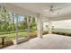 Bright screened porch with ceiling fan and access to backyard at 15890 Sanctuary Dr, Tampa, FL 33647