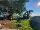 Landscaped backyard features a treehouse and lake views at 1632 28Th S Ave, St Petersburg, FL 33712