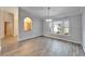 Bright dining room with gray walls, wood-look tile floor, and a chandelier at 1702 Horseshoe Dr, Plant City, FL 33566
