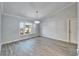Bright dining room with gray walls, wood-look tile floors, and a chandelier at 1702 Horseshoe Dr, Plant City, FL 33566