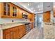 Kitchen with wood cabinets, granite countertops, and stainless steel appliances at 1702 Horseshoe Dr, Plant City, FL 33566