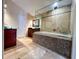 Luxurious bathroom with a soaking tub, mosaic accents, and a glass-enclosed shower at 19809 Wyndham Lakes Dr, Odessa, FL 33556