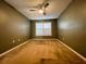 Cozy bedroom with a ceiling fan and a window with shutters at 19809 Wyndham Lakes Dr, Odessa, FL 33556
