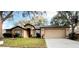 Charming home featuring a well-manicured lawn and attached two-car garage at 19809 Wyndham Lakes Dr, Odessa, FL 33556