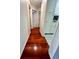 Hallway with wood floors and white walls leading to rooms at 19809 Wyndham Lakes Dr, Odessa, FL 33556