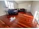 Cozy living room with a comfortable sofa, hardwood floors, and plenty of natural light from the windows at 19809 Wyndham Lakes Dr, Odessa, FL 33556