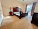Spacious main bedroom with a large bed, furniture set, and sliding glass doors to the patio at 19809 Wyndham Lakes Dr, Odessa, FL 33556