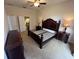 Main bedroom featuring furniture, ceiling fan and access to the main bath at 19809 Wyndham Lakes Dr, Odessa, FL 33556