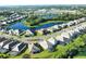 An aerial view of luxurious homes with screened pools along a lakefront community at 19891 Bridgetown Loop, Venice, FL 34293