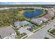 Aerial view of beautiful homes with private pools, tennis courts, and a community lake at 19891 Bridgetown Loop, Venice, FL 34293