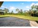 A backyard view from a brick-paved patio shows green grass and a natural preserve at 19891 Bridgetown Loop, Venice, FL 34293