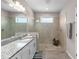 Modern bathroom featuring a walk-in shower and granite countertops at 19891 Bridgetown Loop, Venice, FL 34293