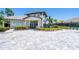 Oasis West Villages entrance featuring manicured landscaping and a welcoming gatehouse at 19891 Bridgetown Loop, Venice, FL 34293