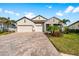 Two-story house with stone accents and a large driveway at 19891 Bridgetown Loop, Venice, FL 34293