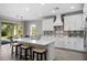 Modern kitchen with white cabinets, quartz countertops, and decorative backsplash at 19891 Bridgetown Loop, Venice, FL 34293