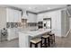 A kitchen island with seating complements this stylish and functional space at 19891 Bridgetown Loop, Venice, FL 34293