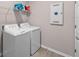 Bright laundry room with washer, dryer, and shelving at 19891 Bridgetown Loop, Venice, FL 34293